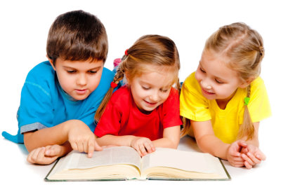 Three kids reading a book