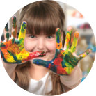 Little girl's hands covered with different kinds of paint