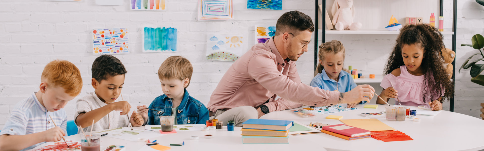man teaching kids to paint